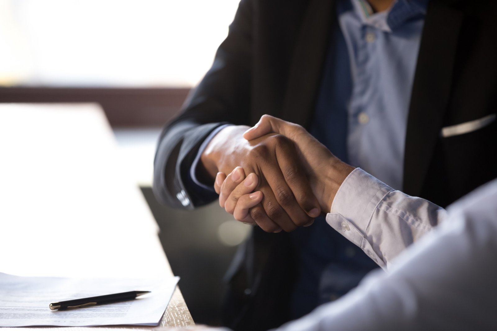 Close,Up,African,American,Businessman,Shaking,Hands,With,Caucasian,Client